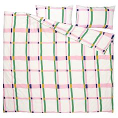 a bed with pink, green and yellow plaid comforter set on top of it