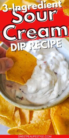 a hand dipping a tortilla chip into a bowl of sour cream dip recipe