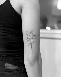 a woman with a flower tattoo on her arm