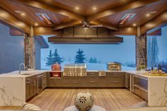 an outdoor kitchen with wood flooring and ceiling