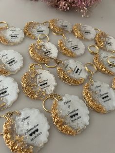 white and gold key chains with names on them