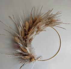 a headband with feathers on it sitting on a white tablecloth covered flooring