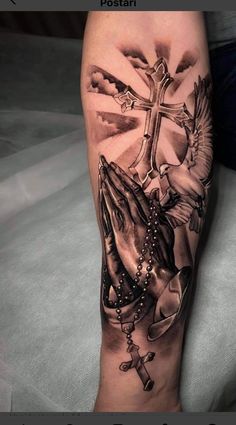 a person with a cross and rosary tattoo on their leg