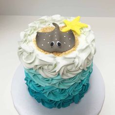 a blue and white cake with an elephant on top