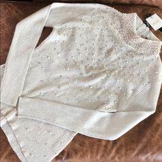 This Beautiful Silver Beaded Knit Top By Belldini Has A Zip Up The Neck. Pearls Adorn The Collar And Front Of The Sweater Along With Silver Beads. This Is The Perfect Top For The Holidays Or For A Special Occasion To Match With Black Pants Or Skirt. Measures 16 Inches Armpit To Armpit And 22 Inches From Neck To Bottom, But Is Stretchy! Size Is Large But Fits More Like A Medium. Elegant Embellished Winter Tops, Elegant Silver Beaded Tops, Elegant Festive Winter Tops, Elegant Embellished Sweater For Fall, Elegant Silver Winter Top, Elegant Silver Tops For Winter, Bead Knit, Silver Beads, Black Pants