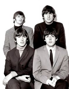 the beatles posing for a black and white photo