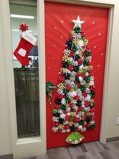 a decorated christmas tree on the front door