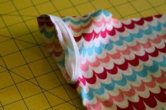 a close up of a piece of cloth on a cutting board with a ruler in front of it