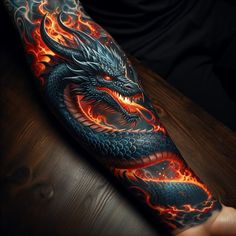 a man's arm with a dragon on it and flames coming out of it