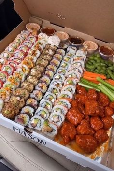 a box filled with lots of different types of sushi and other foods in it