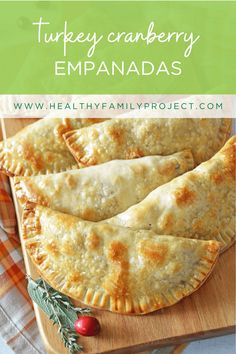 turkey cranberry empanadas on a cutting board with holly sprigs