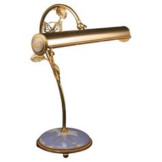 a gold desk lamp with a blue base