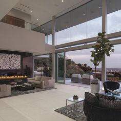 a large living room with two couches and a fire place in the middle of it