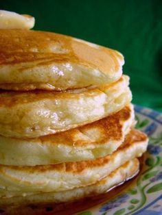 a stack of pancakes sitting on top of a blue and green plate