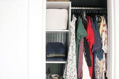 an open closet with clothes and other items