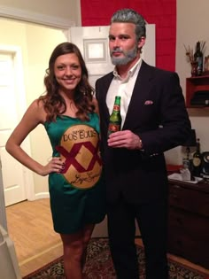 a man standing next to a woman holding a beer