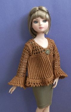 a doll wearing a brown sweater and skirt