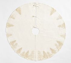 a white and gold circular rug with leaves on it