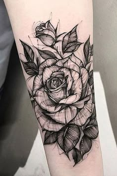 a black and white rose tattoo on the arm