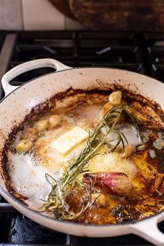 a pan filled with food sitting on top of a stove next to a burner