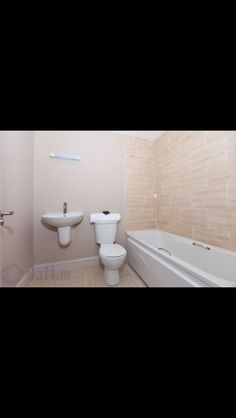 a bathroom with a sink, toilet and bathtub in the corner next to each other