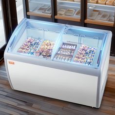 a display case filled with lots of different types of food in front of glass doors