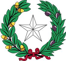 a christmas wreath with an ornament in the shape of a star and bells