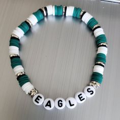 This Is A Philadelphia Eagles Beaded Bracelet In The Eagles Colors Green & White. A Fun Bracelet To Wear Alone Or Stacking With Other Bracelets. These Bracelets Are Made With A Sturdy Elastic Cord Available In Multiple Sizes. Unisex Bracelets Size Guide: 5” - Kids 6” - Small 7” - Average Adult 8” - Large Thank You For Visiting My Store. Www.Simplyfiveheartboutique.Com Avengers Clay Bead Bracelet, Eagles Clay Bead Bracelet, Lyric Bracelet Ideas, Dark Green Clay Bead Bracelet, Philadelphia Eagles Bracelet, Nfl Beaded Bracelets, Football Team Clay Bead Bracelets, Poly Bead Bracelets, Football Clay Bead Bracelets