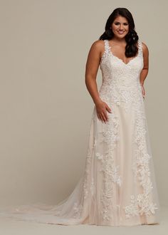 a woman in a wedding dress posing for the camera with her hands on her hips