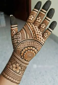 the hand is decorated with intricate designs