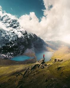 a person standing on top of a mountain overlooking a lake