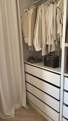 an organized closet with clothes and shoes