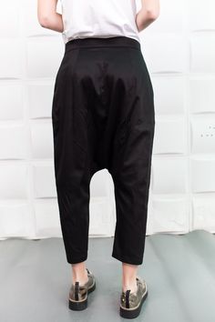 "Black Harem Pants, Cyberpunk Clothing, Drop Crotch Pants These comfortable baggy pants have a drop crotch design an are with an ankle length so these relaxed black cotton pants will make your style trendy and unique and keep you comfortable in your daily activities. ------------------------------------------------ FEATURES: 🌟 Made of cotton fabric 🌟 Two pockets on each side 🌟 Sizes from XS to 5XL - plus sizes available, please write us /the model is wearing size S/ 🌟 Available in black, whi Black Baggy Edgy Bottoms, Punk Baggy Bottoms For Alternative Fashion, Black Wide Leg Alternative Pants, Alternative Style Black Trousers, Edgy Black Tapered Leg Pants, Baggy Alternative Cotton Pants, Baggy Cotton Alternative Style Pants, Baggy Punk Trousers, Black Fitted Drop Crotch Bottoms