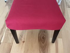 a red chair sitting on top of a wooden floor