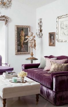 a living room with white walls and purple furniture