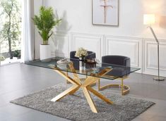 a glass table with gold legs in a living room