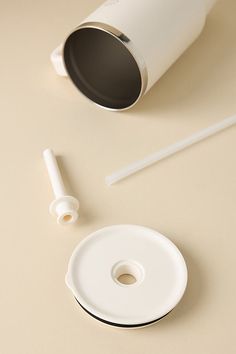 an object is shown on the table next to it's holder and plunger