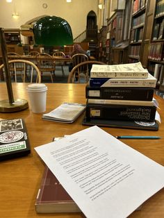 stack of books sitting on top of a wooden table