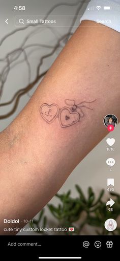 a tattoo on someone's arm with two hearts