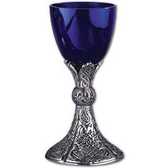 a blue goblet sitting on top of a white table