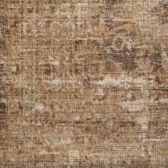 an old, faded rug with brown and tan colors on the surface is shown in this image