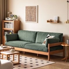 a living room with a green couch and coffee table in front of a large window