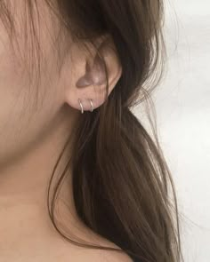 a close up of a person with ear piercings on their ears and back of the head