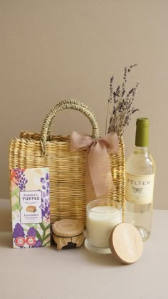 a wicker basket with candles, soap and other items next to it on a table