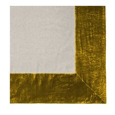 a white and yellow square on top of a piece of cloth with an orange border