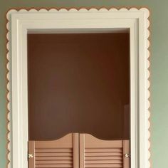 an open door with scalloped trim on the side