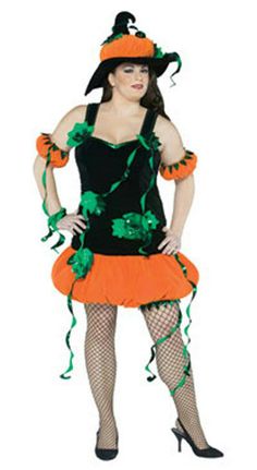 a woman dressed up in a costume with green and orange trimmings, holding her hands on her hips