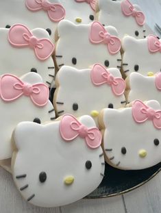 hello kitty cookies with pink bows on them are ready to be cut and served for guests