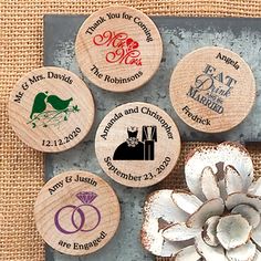 four personalized wooden magnets with wedding rings on them