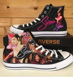 two black high top sneakers with pictures of women on them, one has pink and the other is blue